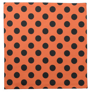 Black polka dots on orange napkin