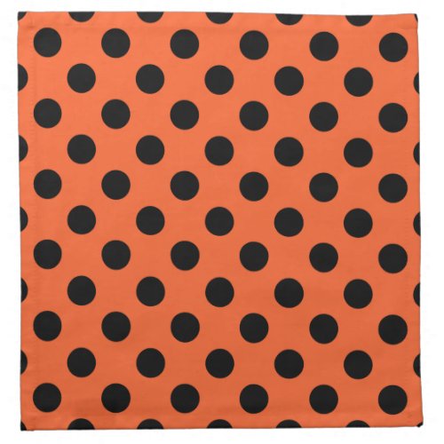 Black polka dots on orange napkin