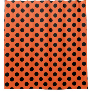 Black polka dots on orange shower curtain