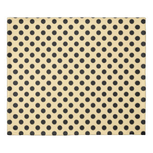 Black polka dots on pale yellow duvet cover