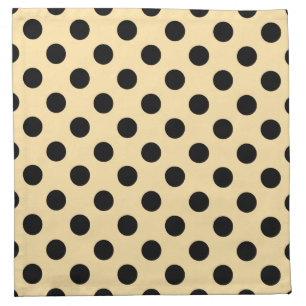 Black polka dots on pale yellow napkin