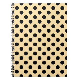 Black polka dots on pale yellow notebook