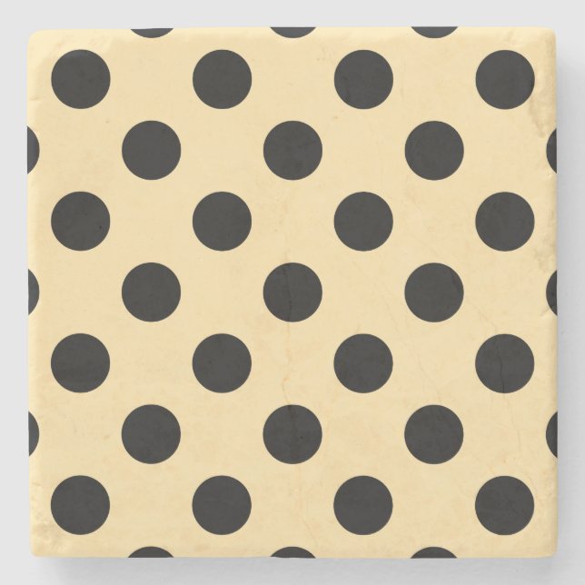 Black polka dots on pale yellow stone coaster (Front)
