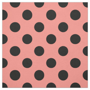 Black polka dots on peach fabric