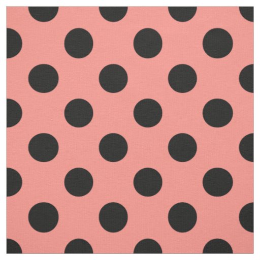 Black polka dots on peach fabric