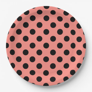 Black polka dots on peach paper plates