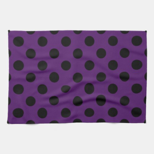 Black polka dots on plum purple towel