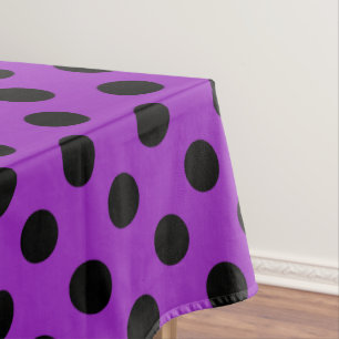 Black polka dots on purple tablecloth