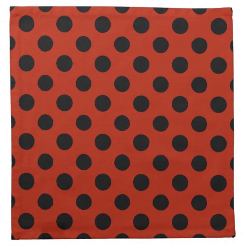 Black polka dots on red napkin