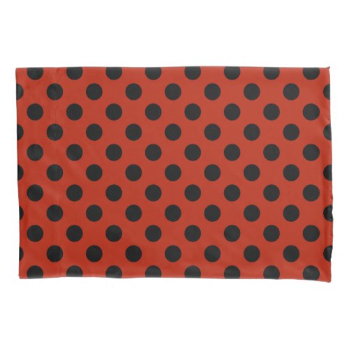 Black polka dots on red pillow case