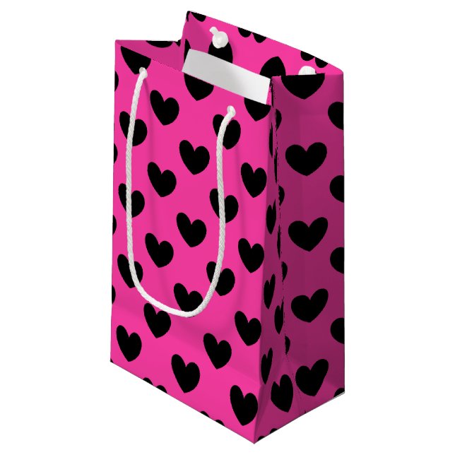 Black polka hearts on fuchsia pink small gift bag (Front Angled)