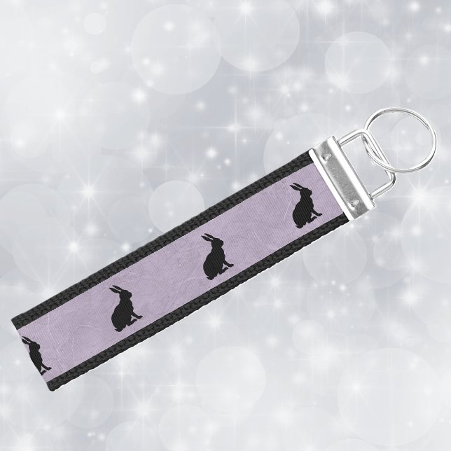 Black Rabbit Silhouette Easter Bunny Wrist Keychain (Rows of black sitting rabbit silhouettes on marbled purple lanyard keychain.)