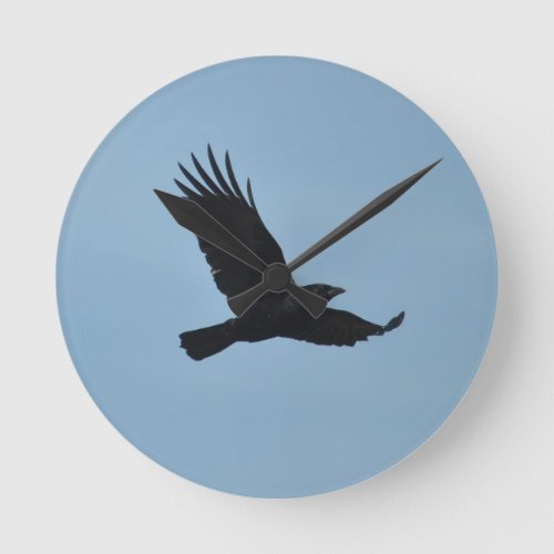 Black Raven Flying in Blue Sky Photo Round Clock
