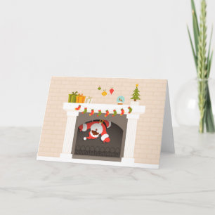 black santa stuck in fireplace holiday card