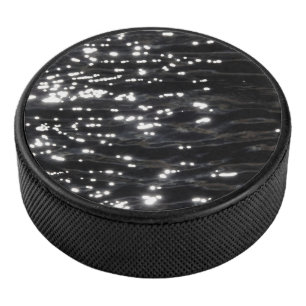Black sparkling water hockey puck