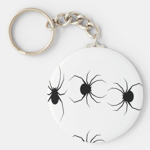 Black spiders on white keychain