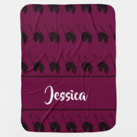 Black sunglasses on burgundy baby blanket