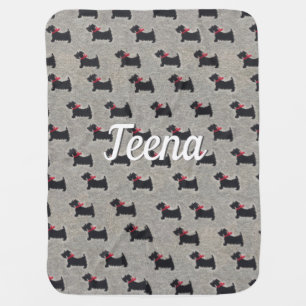 Black terriers with red bow makes a sweet blanket