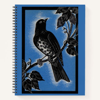black thrush with blue notebook