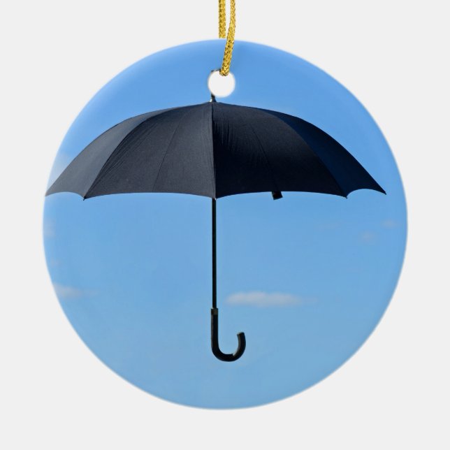 Black umbrella flies in blue sky ceramic ornament (Front)