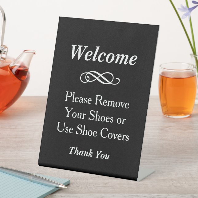 Black Welcome Remove Shoes Covers Pedestal Sign (In SItu)