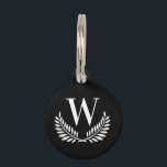 Black white classic wreath monogram initial dog pet ID tag<br><div class="desc">A stylsih black background decorated with a classic wreath . Personalize and add the pet's monogram initial. Add your phone number on the back. White colored letters.</div>