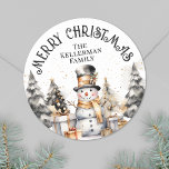 Black White Festive Winter Merry Christmas Classic Round Sticker<br><div class="desc">Add a festive touch to your holiday season with this charming round Christmas sticker featuring a delightful watercolor snowman design. The snowman, in classic black and white, wears a top hat and gold scarf, surrounded by golden accents, festive trees, and presents along the bottom—bringing a whimsical and cozy winter vibe....</div>