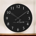 Black White Modern Minimalist Elegant Monogram Round Clock<br><div class="desc">Introducing our Black and White Minimalist Modern Monogram Collection: Embrace simplicity and sophistication with our minimalist designs, curated to elevate your style effortlessly. Crafted with a keen eye for modern aesthetics, this collection features sleek black and white designs accentuated by personalized monograms. From chic stationery to versatile accessories, our collection...</div>