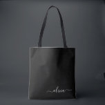 Black White Modern Minimalist Elegant Monogram Tote Bag<br><div class="desc">Introducing our Black and White Minimalist Modern Monogram Collection: Embrace simplicity and sophistication with our minimalist designs, curated to elevate your style effortlessly. Crafted with a keen eye for modern aesthetics, this collection features sleek black and white designs accentuated by personalized monograms. From chic stationery to versatile accessories, our collection...</div>