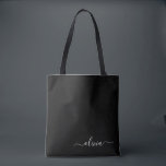 Black White Modern Minimalist Elegant Monogram Tote Bag<br><div class="desc">Introducing our Black and White Minimalist Modern Monogram Collection: Embrace simplicity and sophistication with our minimalist designs, curated to elevate your style effortlessly. Crafted with a keen eye for modern aesthetics, this collection features sleek black and white designs accentuated by personalized monograms. From chic stationery to versatile accessories, our collection...</div>