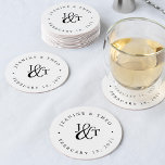 Black & White Wedding Monogram Round Paper Coaster<br><div class="desc">Simple white coasters for your wedding cocktail hour or reception feature your initials worked into a monogram design,  joined by a decorative script ampersand in crisp black. Your names and wedding date appear in black lettering,  curved around the outside. Designed to coordinate with our Ampersand Monogram wedding invitation collection.</div>