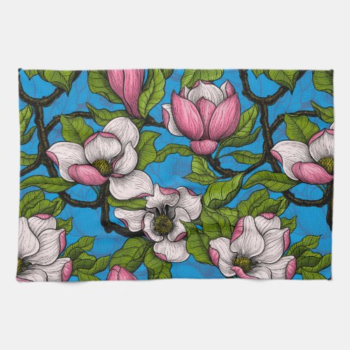 Blooming magnolia on blue kitchen towel