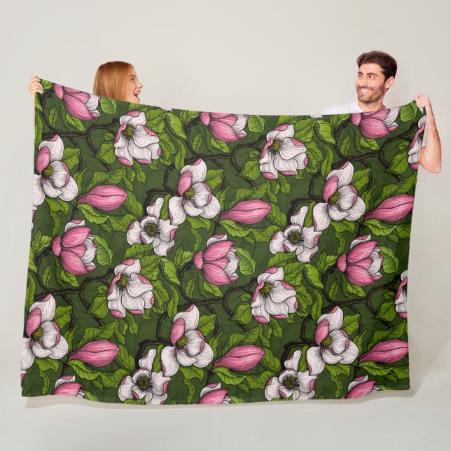 Blooming magnolia on dark green fleece blanket (In Situ)