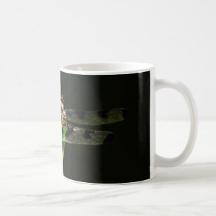 Blue and black Dragonfly on green and red grass Coffee Mug