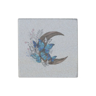 Blue butterflies on wooden crescent stone magnet