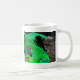 Blue Damselfly on a green leaf. Coffee Mug