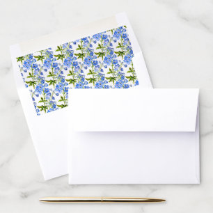 Blue delphinium flowers on white envelope liner