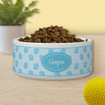 Blue Dog Paws Pattern With Custom Name Bowl<br><div class="desc">Blue dog paw print pattern with a blue badge that has a personalizable text area for the name of the pet. The font is a lovely script font in white color.</div>