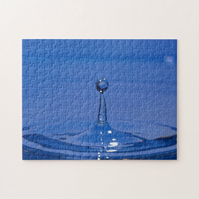 Blue drop of water in motion on a jigsaw puzzle (Horizontal)