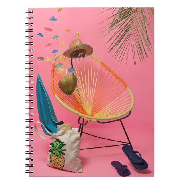 Blue flip-flop beside chair notebook (Front)