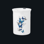 Blue Flying Butterflies Morpho Beverage Pitcher<br><div class="desc">Flying Blue Butterflies morpho and white butterflies on a light abstract background. Morpho. Design with blue butterflies morpho.</div>