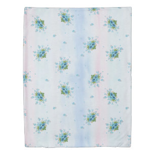 Blue forget-me-not's on a soft pink-blue duvet cover