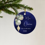 Blue gold white baubles Christmas Ceramic Ornament<br><div class="desc">A blue uneven colored background. Decorated with white and gold baubles and some greenery and a pine cone.  Personalize and add your name,  year.  Text: Merry Christmas</div>