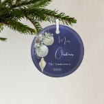 Blue gold white baubles Christmas Glass Ornament<br><div class="desc">A blue uneven colored background. Decorated with white and gold baubles and some greenery and a pine cone.  Personalize and add your name,  year.  Text: Merry Christmas</div>