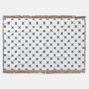 Blue-gray cross stitches on white throw blanket