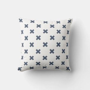 Blue-gray cross stitches on white throw pillow