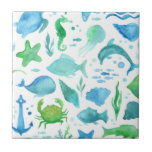Blue green sea ocean fish dolphin white nautical ceramic tile<br><div class="desc">Under the sea,  ocean theme.  A chic white background with a watercolored pattern of marine life,  fish,  dolphins,  a whale,  turtle,  seahorse,  jellyfish in green,  blue and teal.  Perfect for a beach house,  cottage or summer  home.</div>