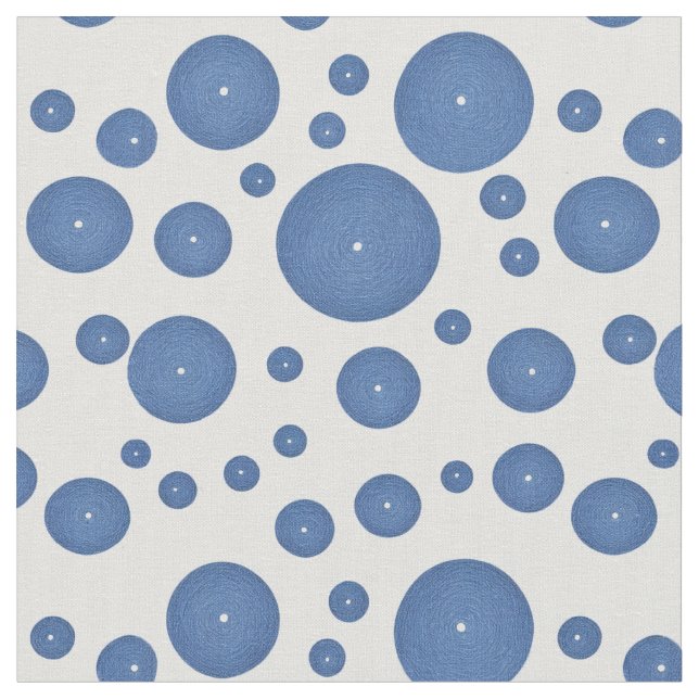 Blue knitted circles on a white background fabric (Close Up)