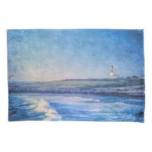 Blue lighthouse in evening and ocean waves pillow case