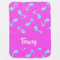 Blue musical notes on pink baby blanket